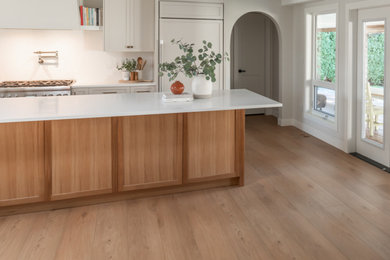 Kitchen photo in Vancouver with shaker cabinets, quartzite countertops, white backsplash, stainless steel appliances, an island and white countertops