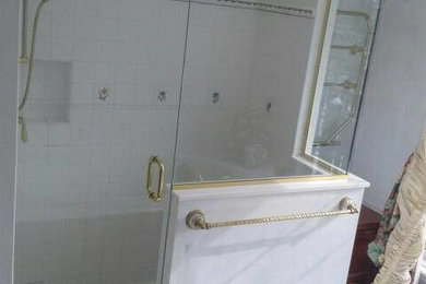 This is an example of a contemporary bathroom in Philadelphia with a corner shower and white tile.