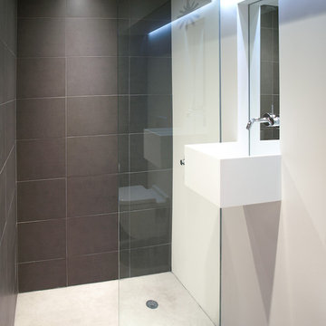 white corian and concrete bathroom
