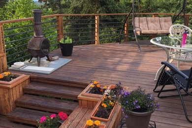 Inspiration for a large craftsman backyard deck container garden remodel in Other