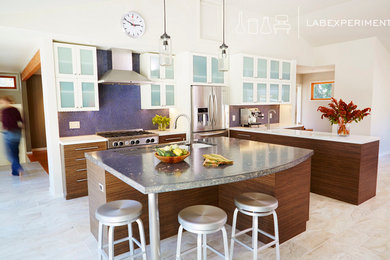Large 1960s single-wall porcelain tile eat-in kitchen photo in San Francisco with an undermount sink, flat-panel cabinets, medium tone wood cabinets, concrete countertops, blue backsplash, ceramic backsplash, stainless steel appliances and an island