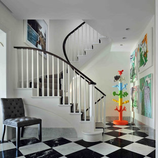 Large contemporary painted wood curved staircase in London with painted wood risers.