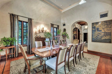 Example of a mid-sized tuscan carpeted and green floor enclosed dining room design in Austin