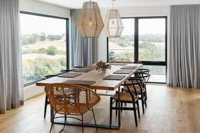 Design ideas for a contemporary dining room in Other with white walls, medium hardwood floors and brown floor.