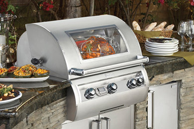 Example of a small arts and crafts backyard patio kitchen design in Orange County with no cover