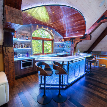Glass private bar and glass stair treads inside a man cave in Michigan