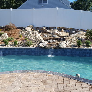 Gray plaster gunite pool with waterfall