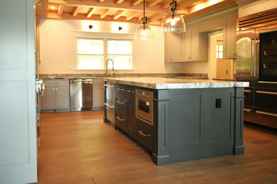 Elegant eat-in kitchen photo with recessed-panel cabinets, gray cabinets and an island