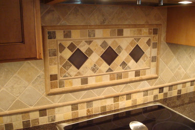 Example of a mid-sized transitional l-shaped travertine floor open concept kitchen design in St Louis with an undermount sink, flat-panel cabinets, light wood cabinets, granite countertops, beige backsplash, stone tile backsplash, stainless steel appliances and an island