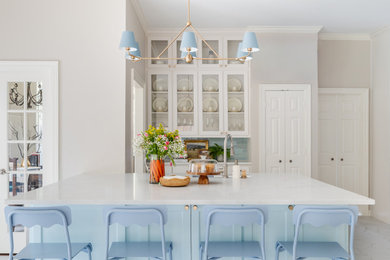 Eat-in kitchen - mid-sized transitional u-shaped porcelain tile and multicolored floor eat-in kitchen idea in Dallas with a farmhouse sink, shaker cabinets, white cabinets, quartz countertops, blue backsplash, ceramic backsplash, stainless steel appliances, a peninsula and white countertops