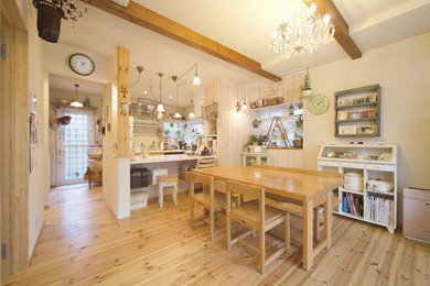 Photo of a country open plan dining in Other with white walls, light hardwood floors and brown floor.