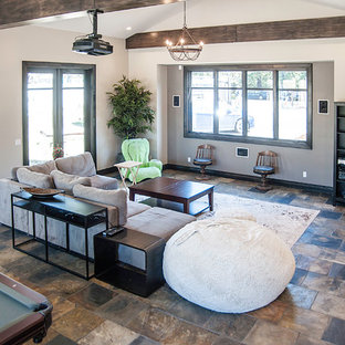 Large contemporary open plan home cinema in San Francisco with slate flooring and a projector screen.