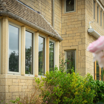 Cotswold stone with RAL 7032 Pebble Grey Aluminium windows