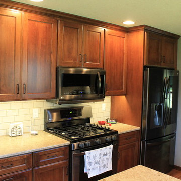 Dynasty by Omega Cabinetry. Wyatt door, Cherry wood, Nutmeg stain, Onyx glaze.