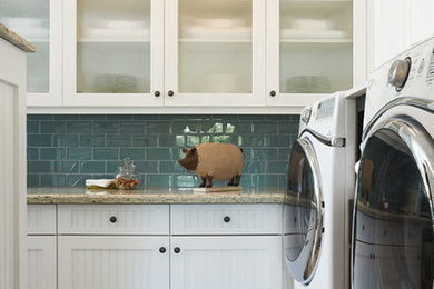 Inspiration for a mid-sized eclectic l-shaped medium tone wood floor utility room remodel in Los Angeles with shaker cabinets, white cabinets, white walls and a side-by-side washer/dryer