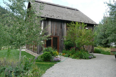 Example of a mid-sized farmhouse gray two-story wood gable roof design in Burlington