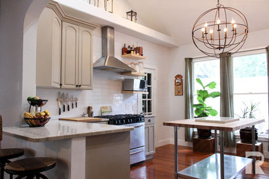 Inspiration for a mid-sized farmhouse eat-in kitchen remodel in Austin with two islands