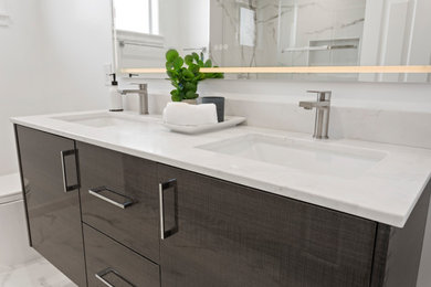 Inspiration for a mid-sized modern 3/4 gray tile and marble tile marble floor, gray floor and double-sink bathroom remodel in San Francisco with flat-panel cabinets, brown cabinets, a one-piece toilet, white walls, an undermount sink, marble countertops, gray countertops and a floating vanity
