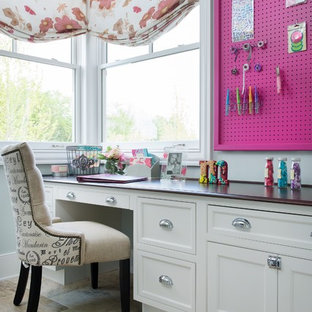 Inspiration for a small traditional craft room in Kansas City with grey walls, limestone floors, no fireplace and a built-in desk.