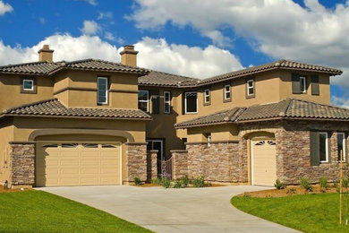 Example of a mid-sized classic beige two-story mixed siding exterior home design in Other with a tile roof
