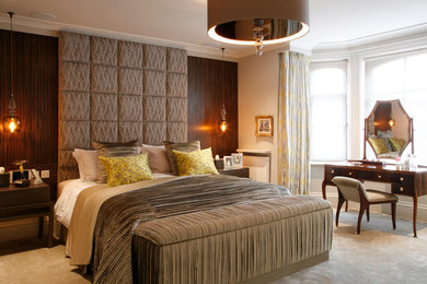 This is an example of a contemporary bedroom in London with beige walls and carpet.