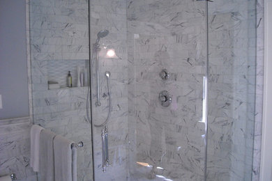 Example of a mid-sized classic master white tile and stone tile marble floor corner shower design in Baltimore with a one-piece toilet, gray walls and a console sink