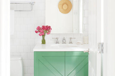 Inspiration for a small transitional 3/4 white tile and ceramic tile ceramic tile and multicolored floor alcove shower remodel in New York with recessed-panel cabinets, green cabinets, an undermount sink, solid surface countertops, a hinged shower door and white countertops