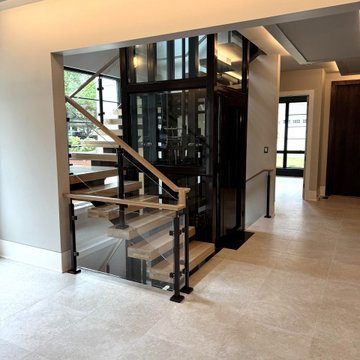 Project #136 | Modern Floating Staircase Encircling Glass Elevator