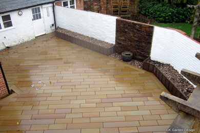 Inspiration for a medium sized contemporary courtyard patio in Hampshire with natural stone paving and a pergola.