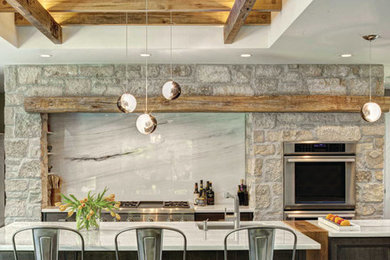 Example of a transitional galley dark wood floor kitchen design in Chicago with recessed-panel cabinets, dark wood cabinets, white backsplash, stainless steel appliances, an island and marble backsplash