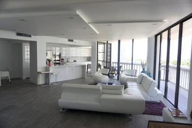 Large modern formal open concept living room in Miami with white walls, concrete floors, no fireplace, no tv and grey floor.