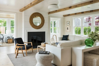 Inspiration for a large coastal open concept light wood floor and beige floor family room remodel in Providence with beige walls, a standard fireplace and no tv