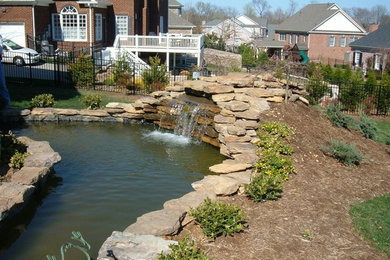 Inspiration for a mid-sized rustic backyard stone and custom-shaped natural pool fountain remodel in Nashville