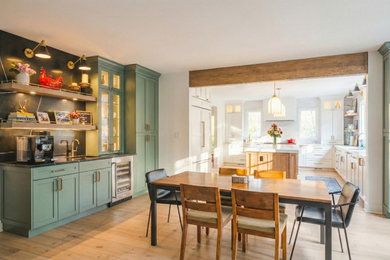 Open concept kitchen - large transitional l-shaped light wood floor, beige floor and exposed beam open concept kitchen idea in DC Metro with an undermount sink, shaker cabinets, white cabinets, quartz countertops, white backsplash, ceramic backsplash, stainless steel appliances, an island and white countertops