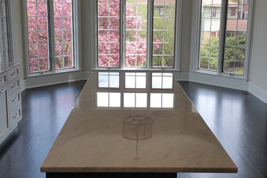 Inspiration for a transitional dark wood floor and brown floor kitchen remodel in Chicago with shaker cabinets, marble countertops and an island