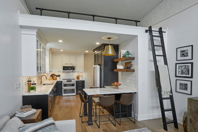 Example of a small transitional kitchen design in Indianapolis with beaded inset cabinets, quartz countertops and white backsplash