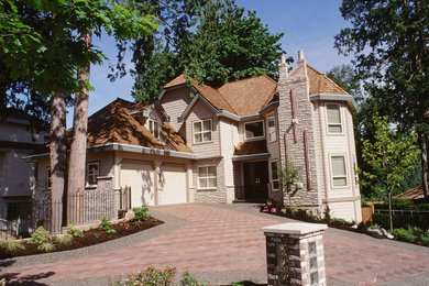Large traditional beige two-story exterior home idea in Vancouver