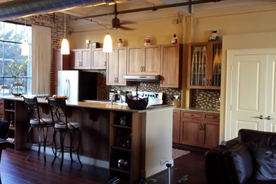 Small urban single-wall eat-in kitchen photo in Other with an undermount sink, shaker cabinets, medium tone wood cabinets, granite countertops, multicolored backsplash, glass sheet backsplash, stainless steel appliances and an island