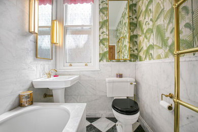 Design ideas for a small classic family bathroom in London with a built-in bath, a one-piece toilet, white tiles, ceramic tiles, multi-coloured walls, ceramic flooring, a pedestal sink, multi-coloured floors and a single sink.