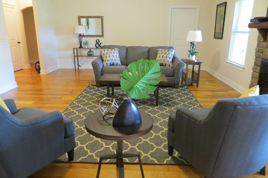 Example of a large transitional formal and enclosed light wood floor and brown floor living room design with white walls, a standard fireplace and a stone fireplace