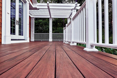 Inspiration for a large timeless backyard deck remodel in Other with a pergola