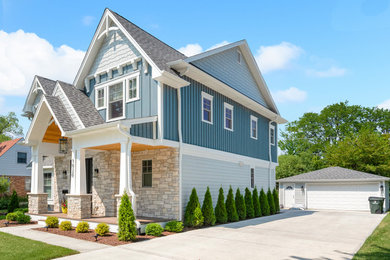 Example of a trendy blue two-story mixed siding exterior home design in Chicago with a shingle roof