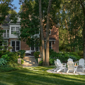 Flagstone raised patio that steps down to a lower raised firepit area