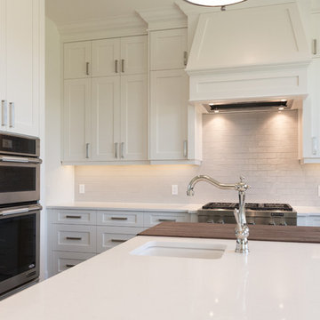 White shaker style Kitchen with custom hood and butcher block countertop