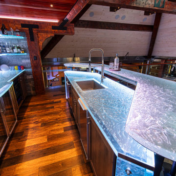 Glass private bar and glass stair treads inside a man cave in Michigan