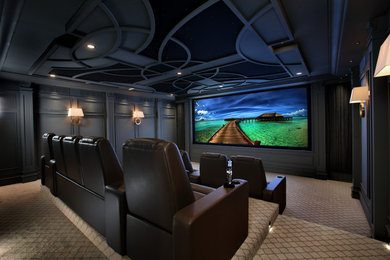 This is an example of a large traditional enclosed home theatre in Toronto with grey walls, carpet and a projector screen.
