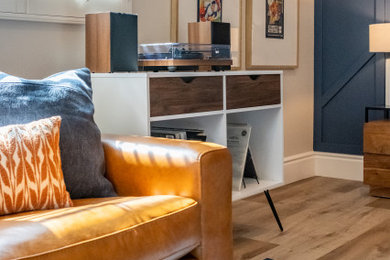 Example of a large mid-century modern vinyl floor, beige floor and wall paneling bedroom design in Los Angeles with blue walls