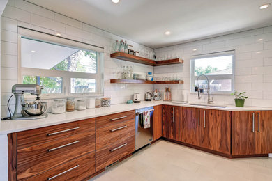 Example of a mid-sized minimalist l-shaped porcelain tile enclosed kitchen design in San Luis Obispo with an undermount sink, flat-panel cabinets, medium tone wood cabinets, quartz countertops, white backsplash, porcelain backsplash and stainless steel appliances