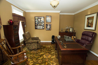 Study room - mid-sized traditional freestanding desk medium tone wood floor study room idea in DC Metro with brown walls