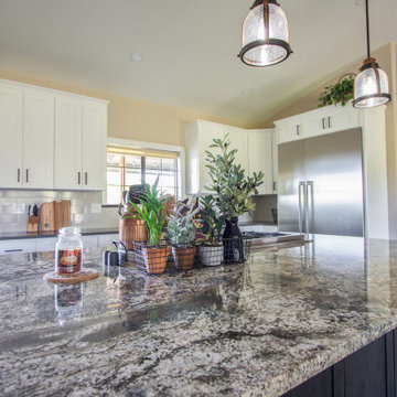 Spacious kitchen remodel using warm taupe, white and brown tones